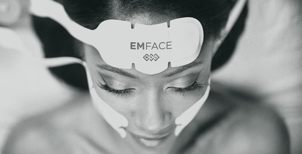 woman laying down for an EMFACE treatment